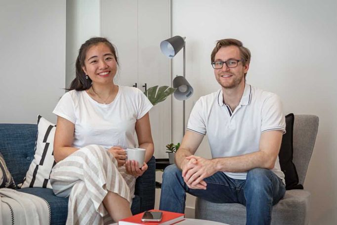 couple-sitting-in-lounge-smiling